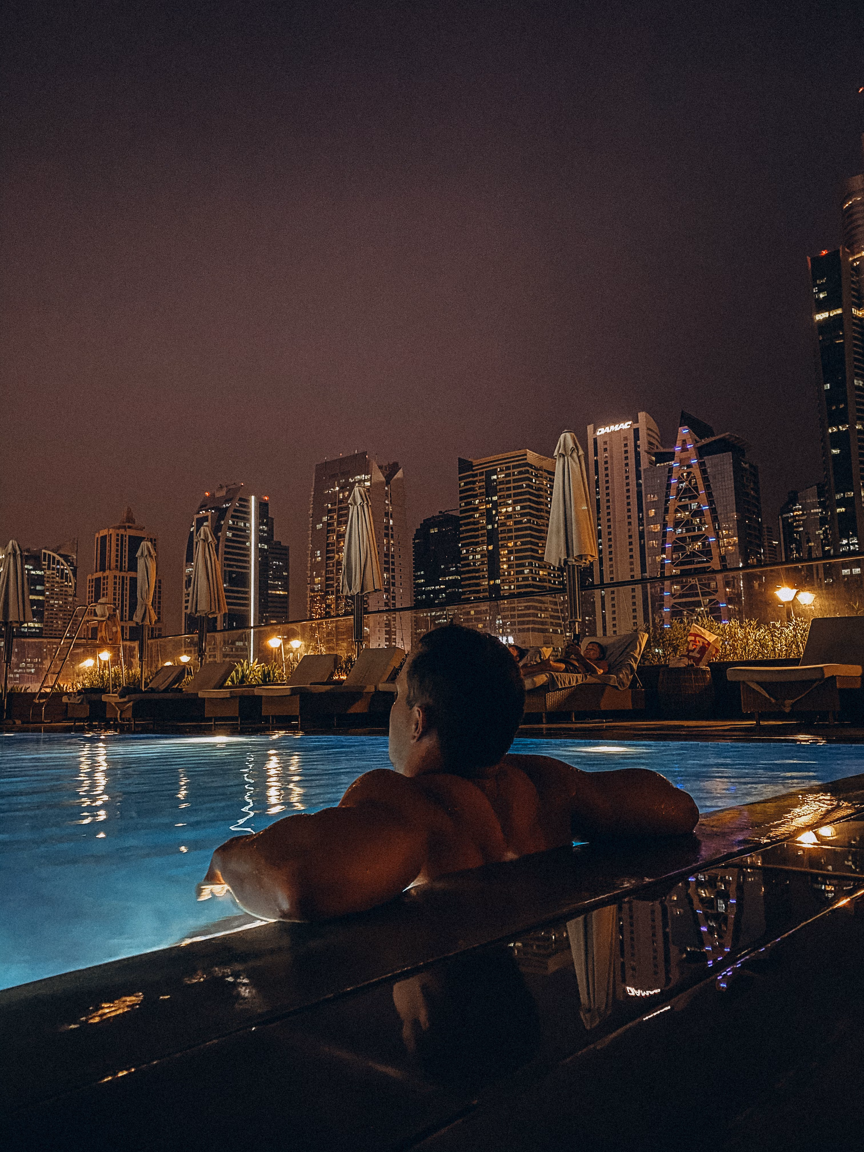 A member at the pool edge at night